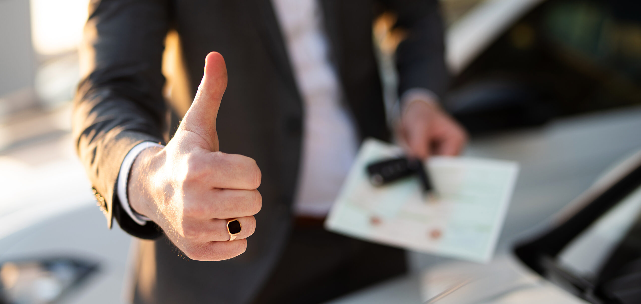 Man giving a thumbs up holding keys